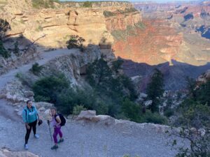 Two women hiking near the top of the Grand Canyon.