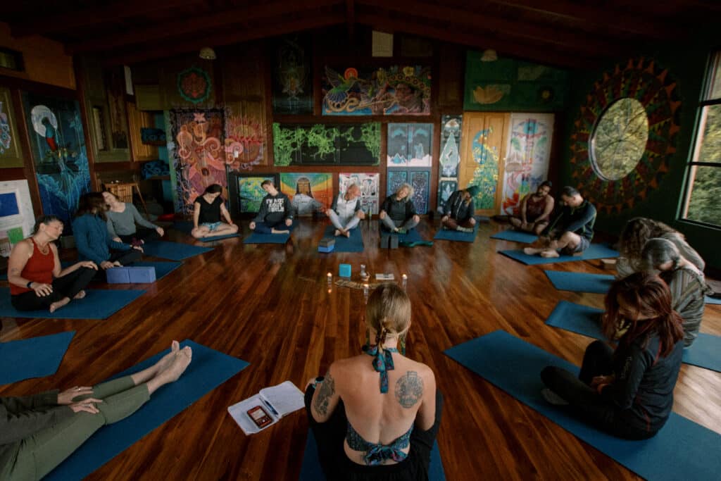 Yoga is a practice for finding liberation from suffering and separation. Group of yogis in an indoor yoga retreat studio in Costa Rica.